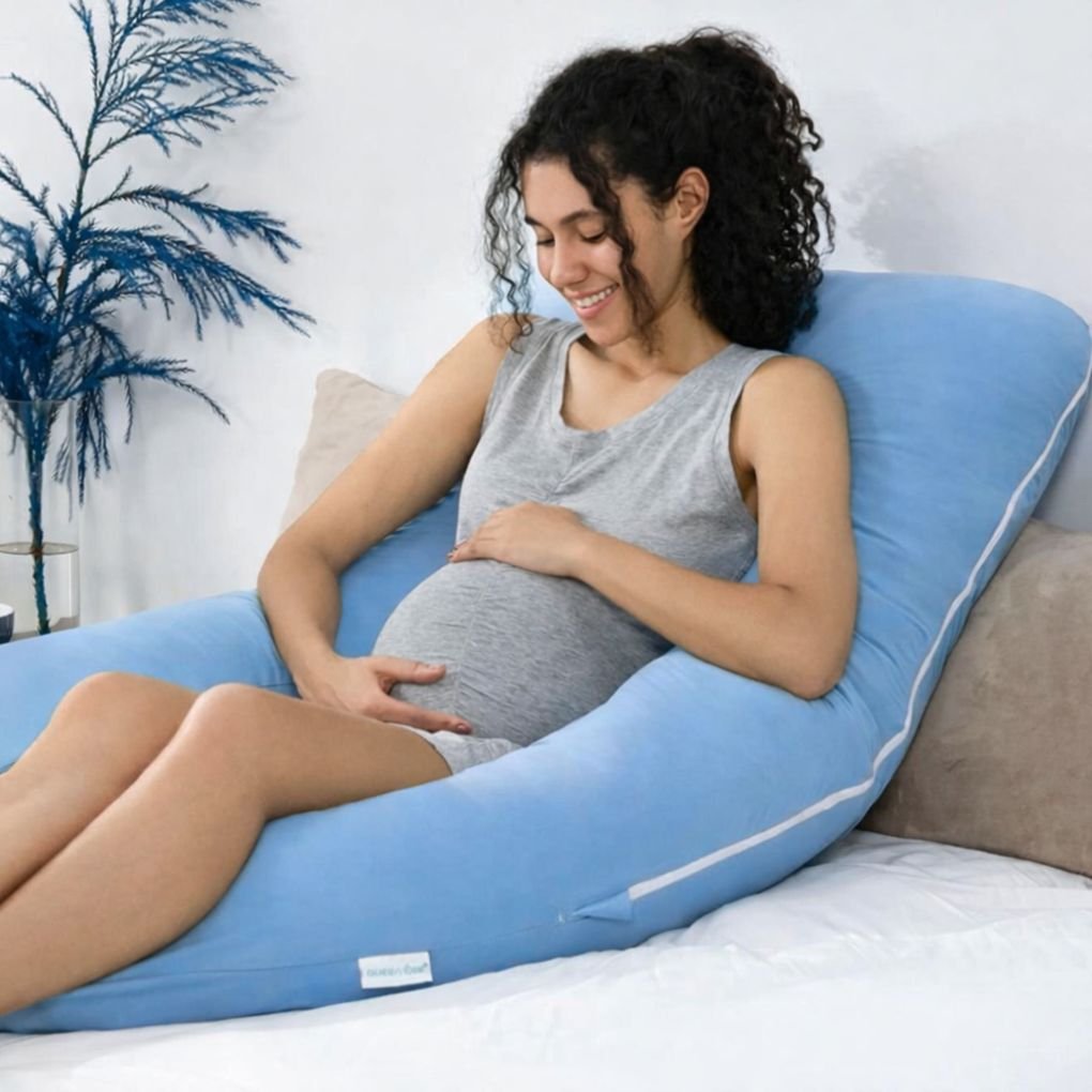 U shaped pregnancy pillow placed on a bed showing full body comfort solution for Indian mothers during pregnancy